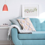 Vibrant Sofa Decorated With Cushions And Woolen Plaid, Small Cab